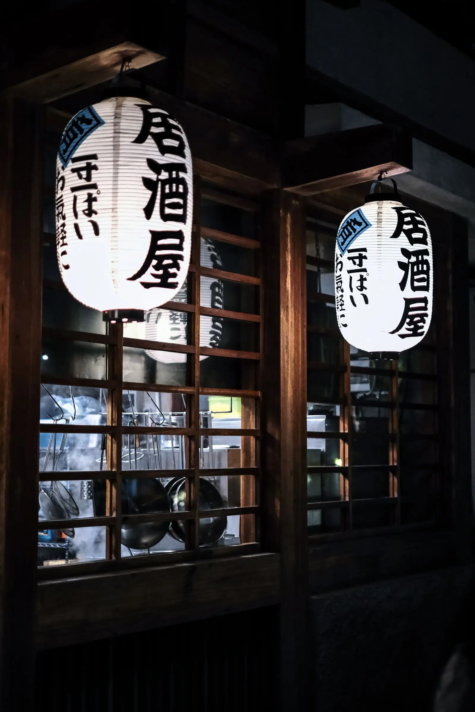 A paper lantern glowing at the entrance at night